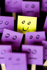 43607229 - hand drawn faces on sticky notes with on that stands out in a positive way